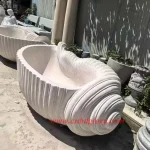 Conch shaped white marble bathtub